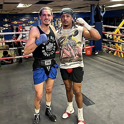 Two boxers posing in the Blue Boy ring after training