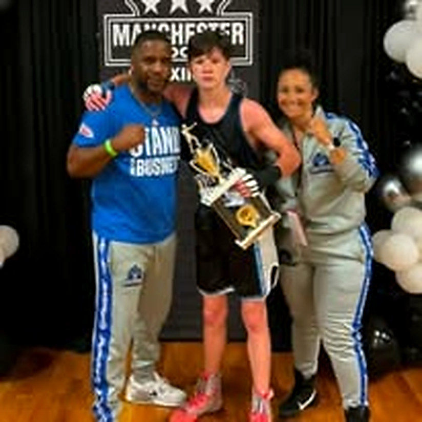Kareem Blue on the left and Nina Blue on the right with a Blue Boy boxer holding a trophy