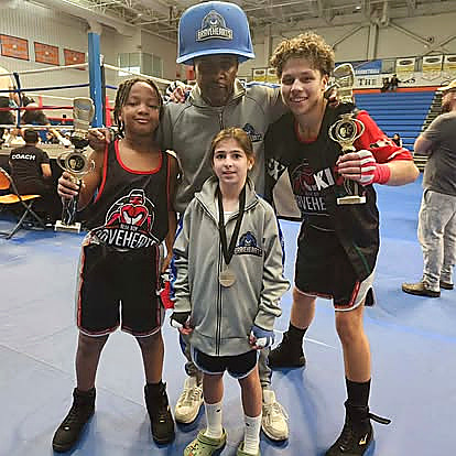 Youth boxers with trophies after a Blue Boy event